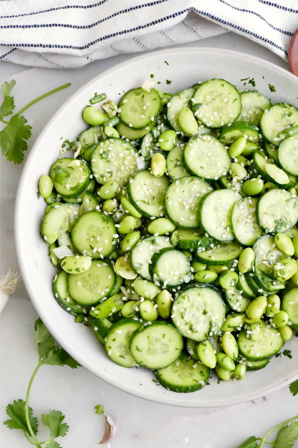 Cold cucumber and edamame salad with sesame seeds and ginger dressing.