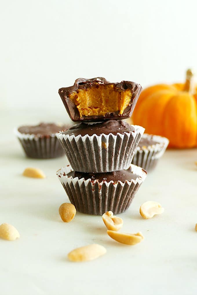 A stack of three vegan peanut butter pumpkin cups.