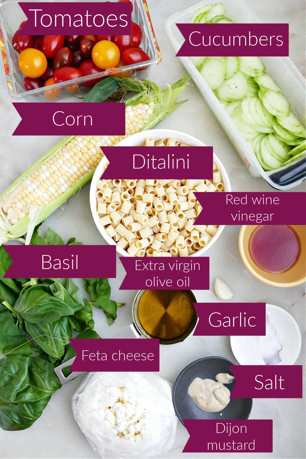 Cherry tomatoes, corn, cucumber, ditalini pasta, vinegar, oil, mustard, garlic, salt, and basil with labels.