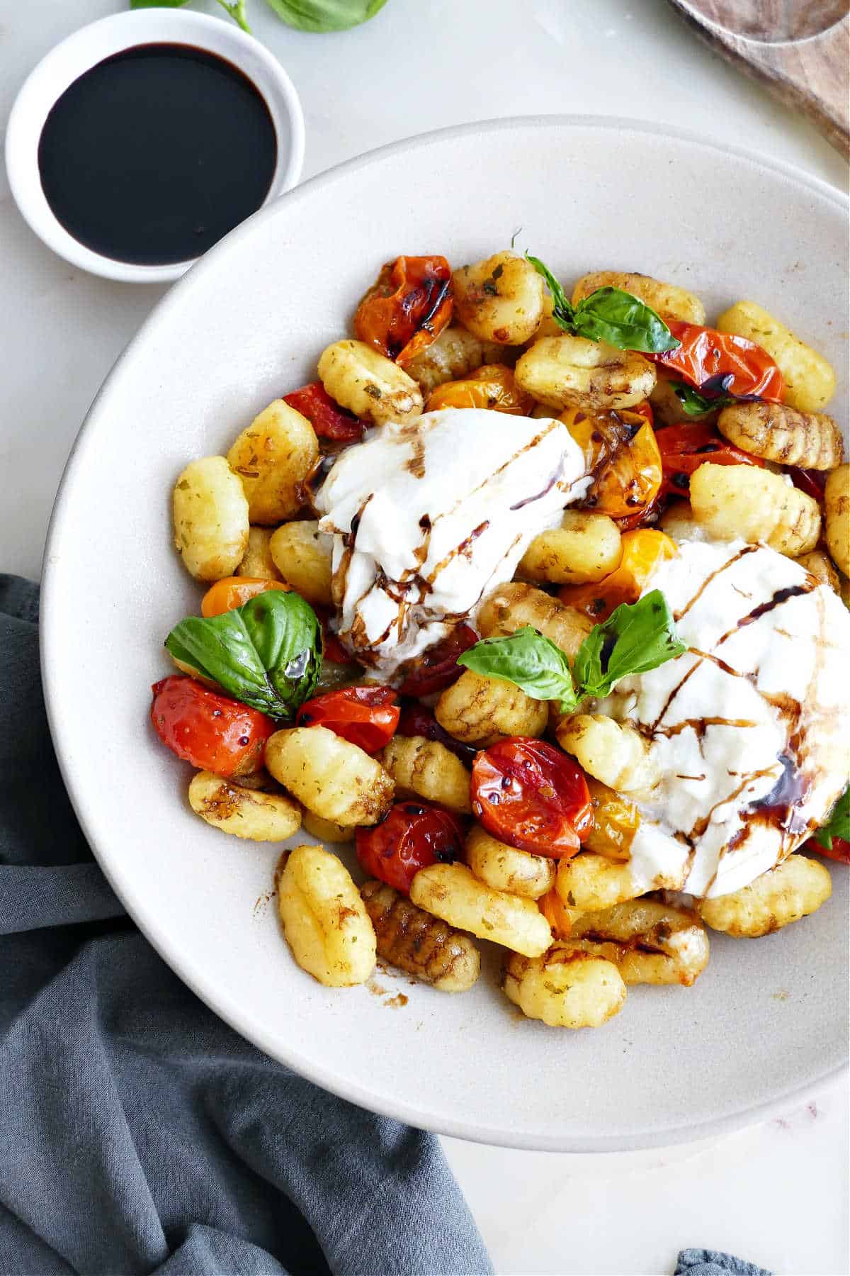 Gnocchi Caprese sheet pan dinner served with burrata cheese in a bowl.
