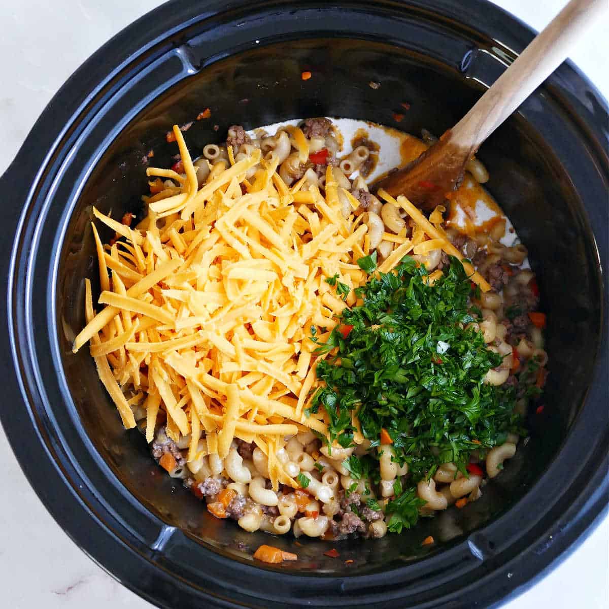 Shredded cheese, parsley, and milk, stirred into hamburger helper.