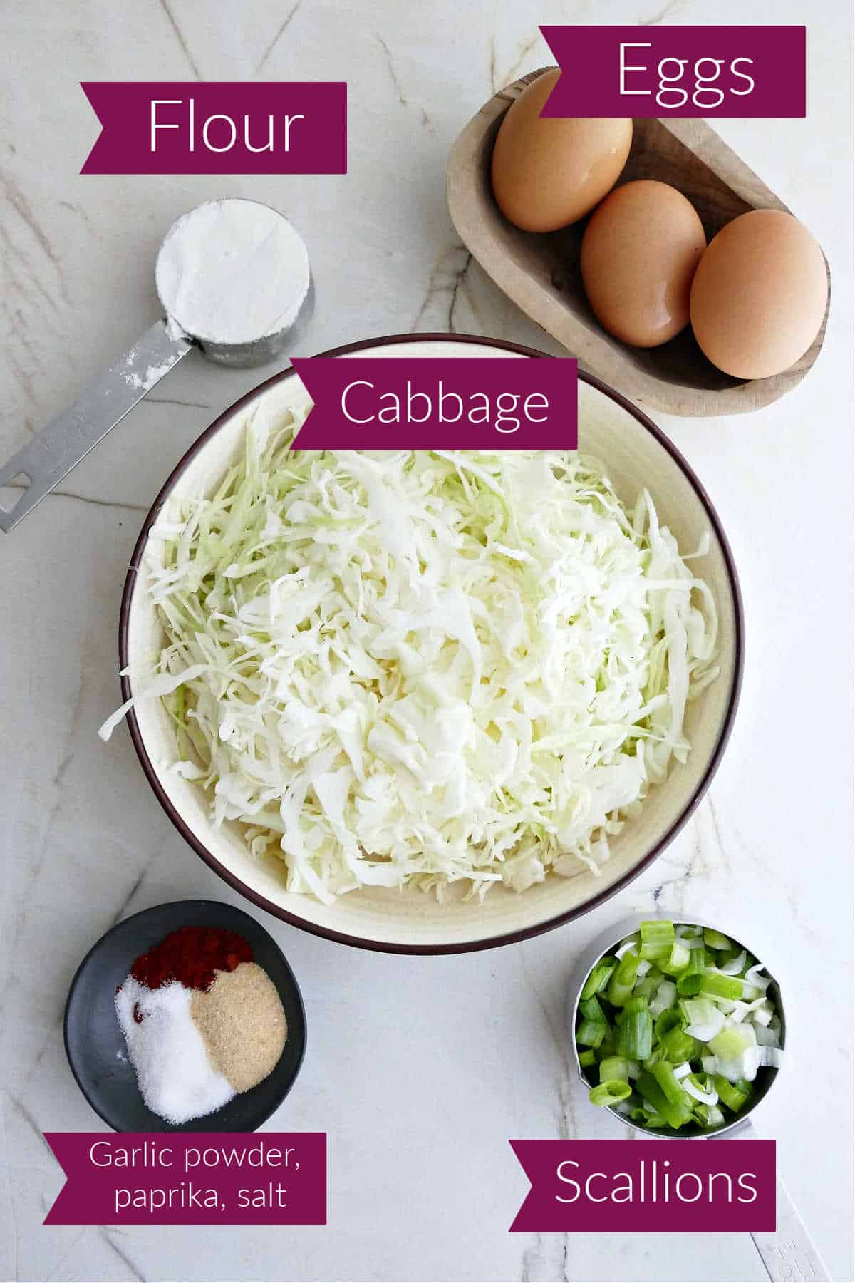 Flour, eggs, shredded cabbage, scallions, and spices in bowls with labels.