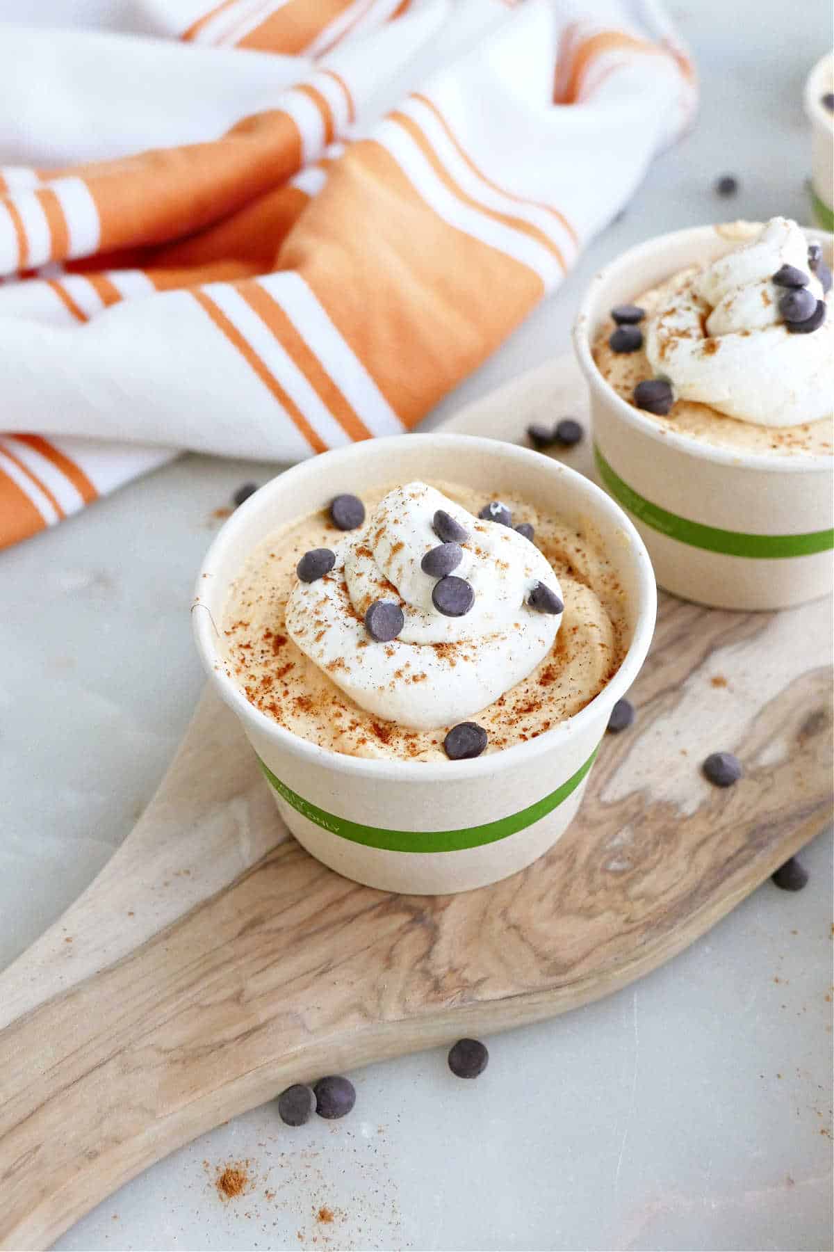 Easy pumpkin pie mousse in a cup topped with whipped cream and chocolate chips.