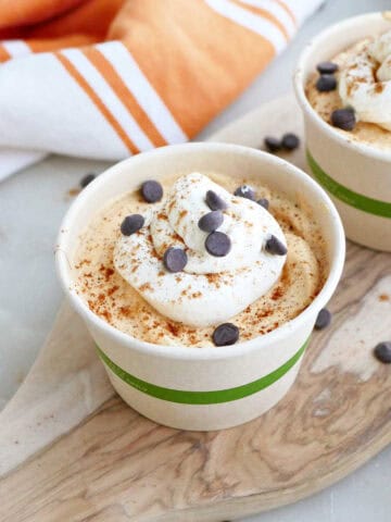 Easy pumpkin pie mousse in a cup topped with whipped cream and chocolate chips.