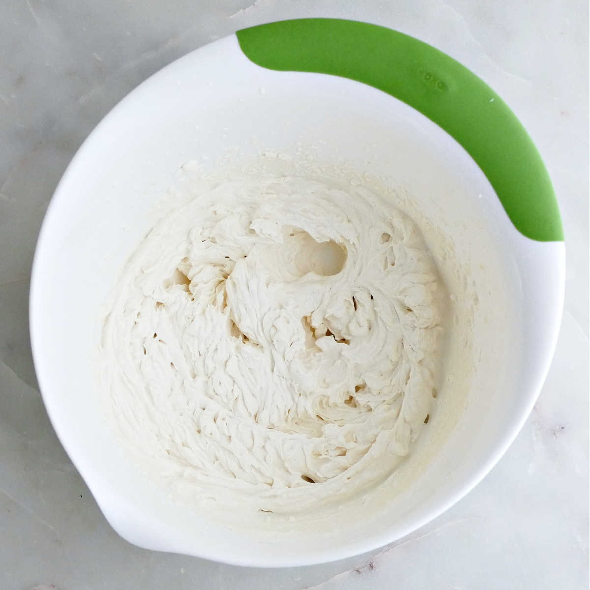Heavy cream whipped until medium peaks form in a mixing bowl.