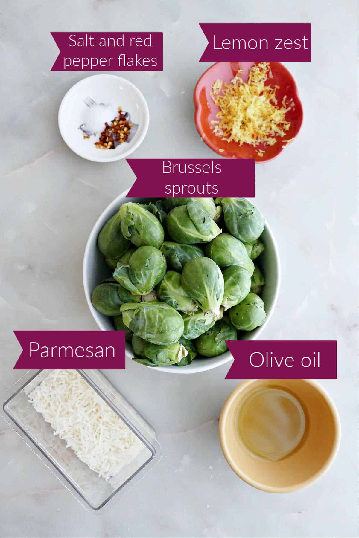 Salt and red pepper flakes, lemon zest, Brussels sprouts, olive oil, and parmesan with labels.