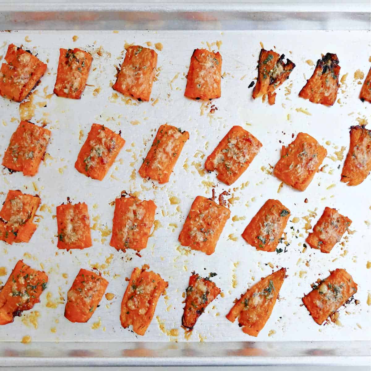 Smashed carrots on a sheet pan after being roasted.