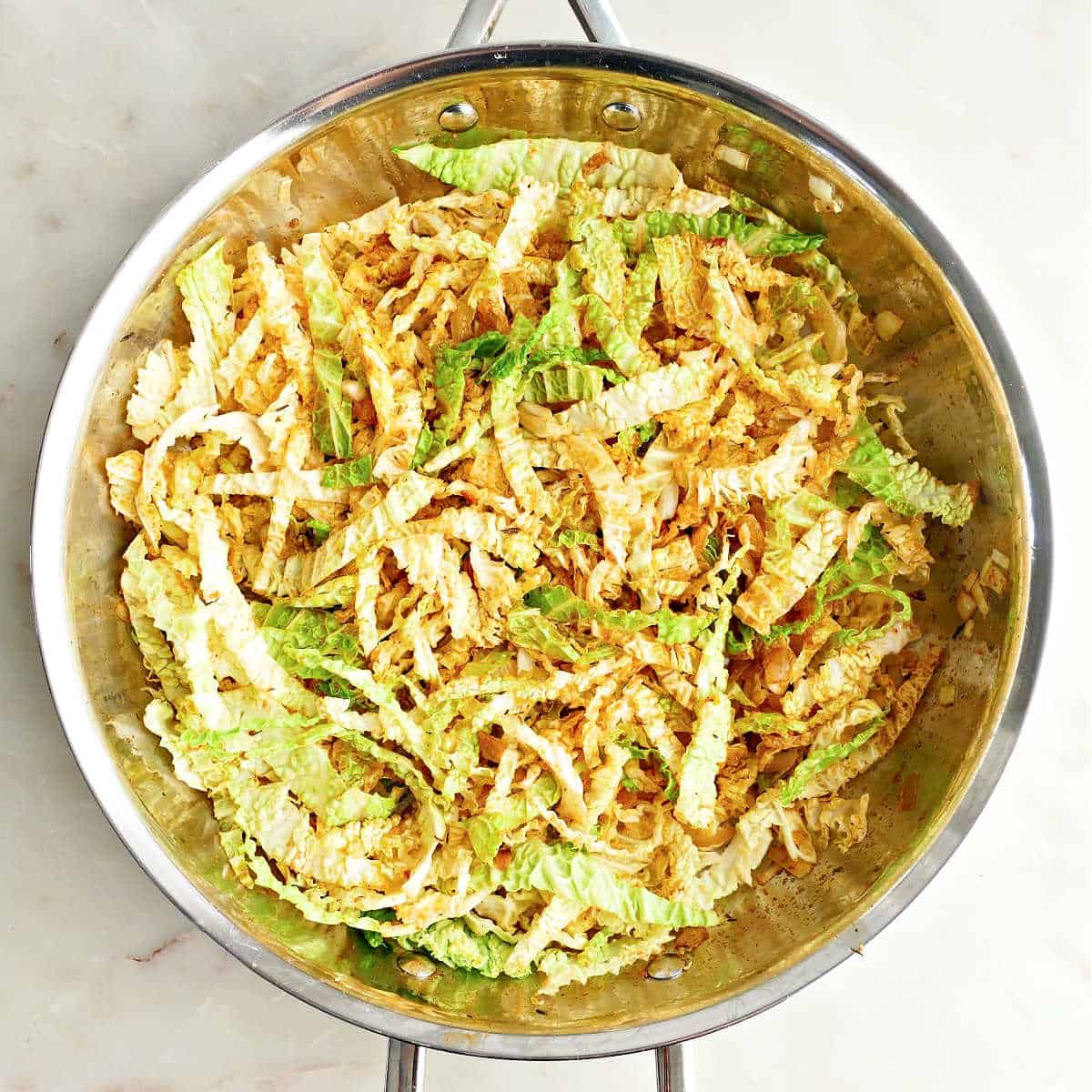 Cabbage, onion, garlic, and spices cooked down in a skillet.
