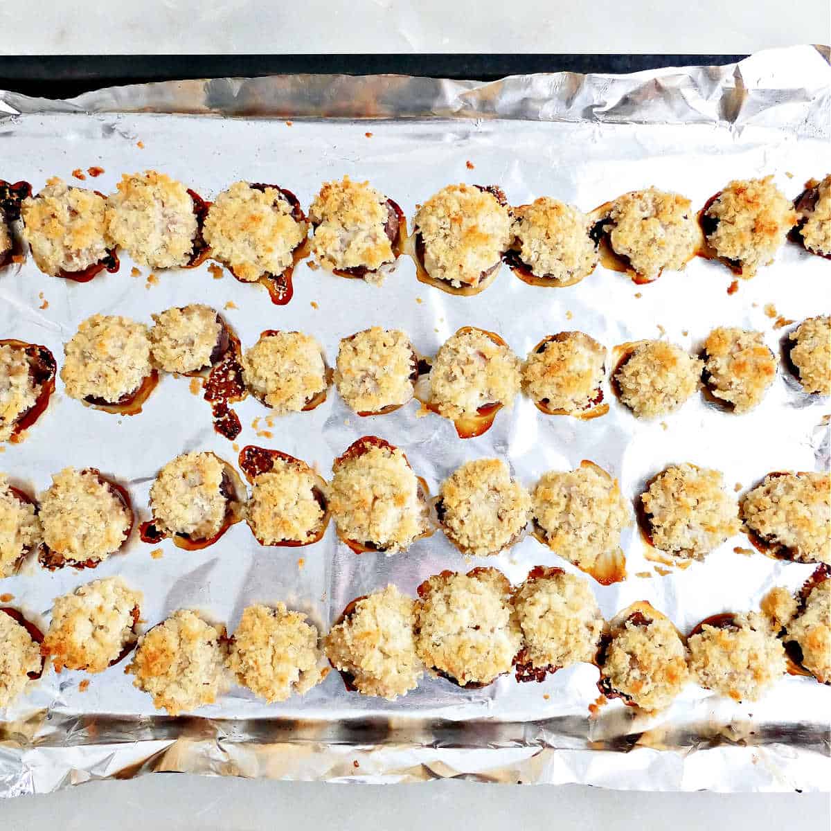 Boursin stuffed mushrooms on a baking sheet after coming out of the oven.