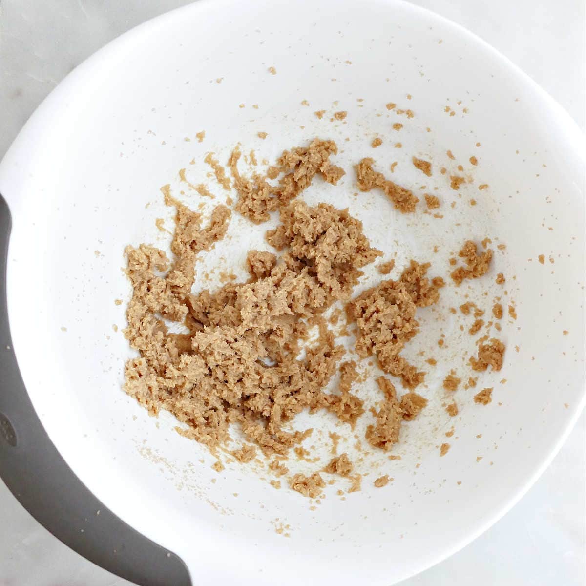 Butter and brown sugar creamed in a mixing bowl.