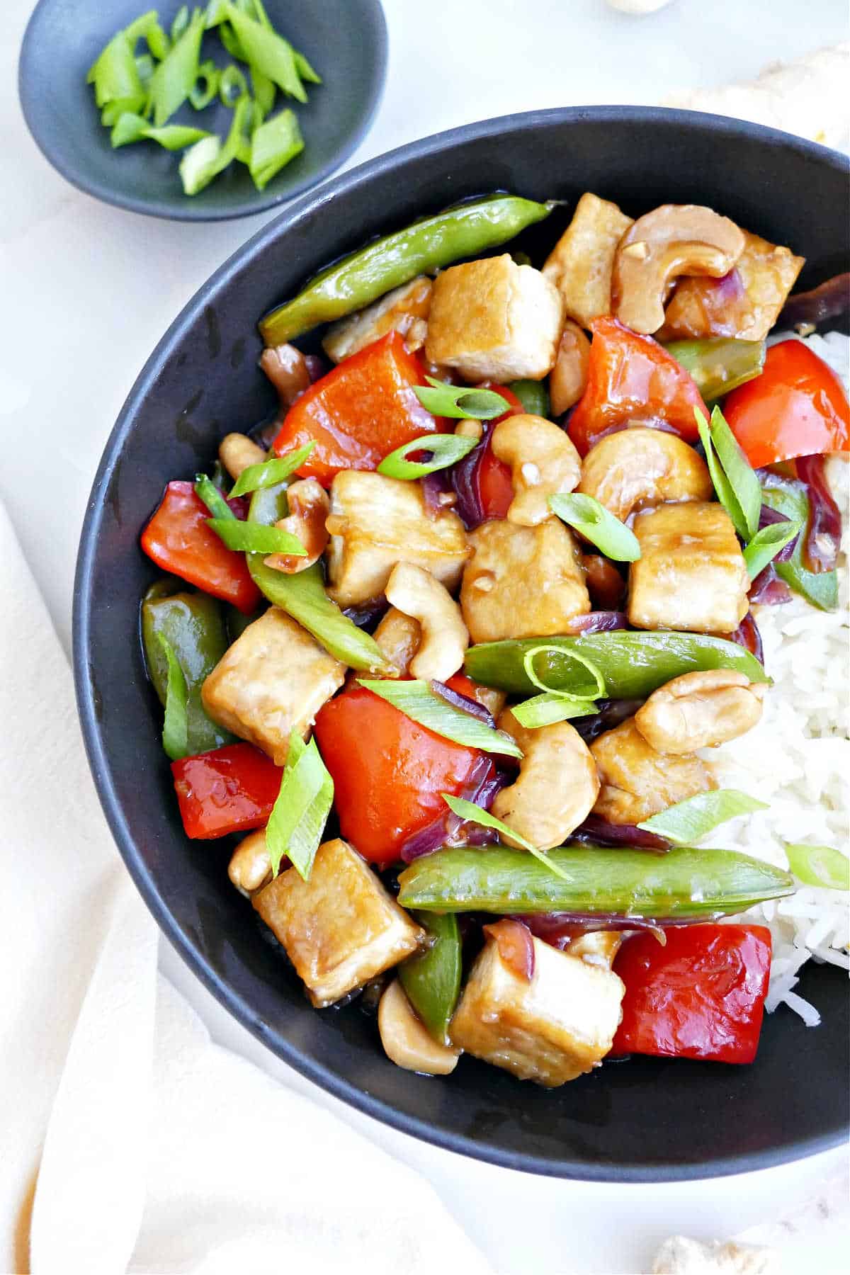 Cashew stir fry with tofu and rice in a bowl.