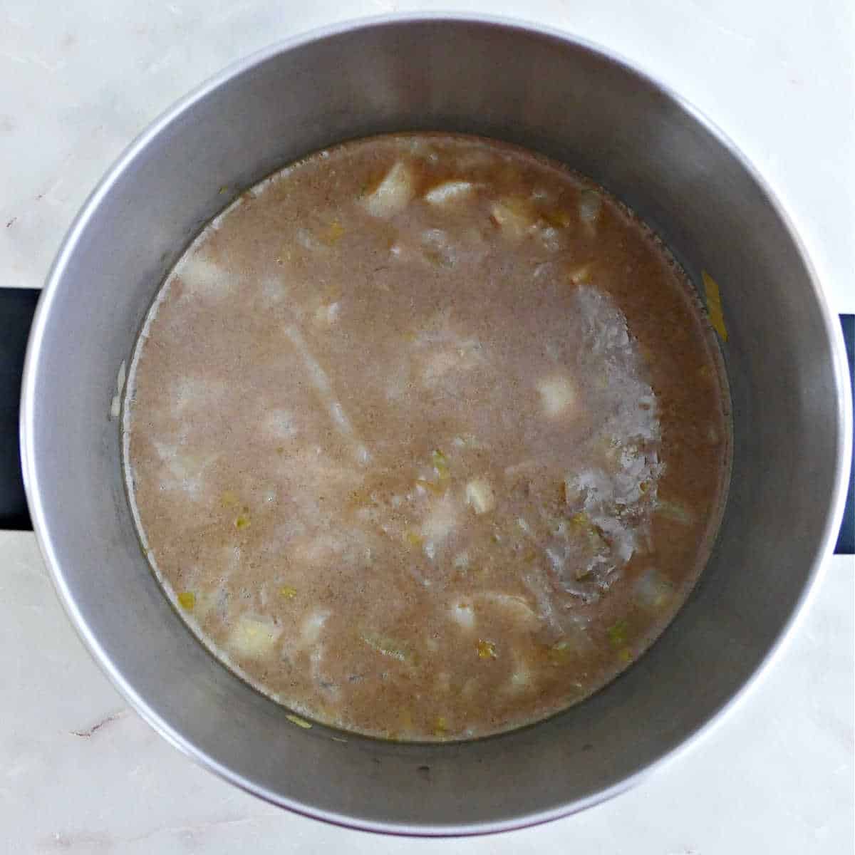 Parsnip leek soup after simmering in a pot before blending.