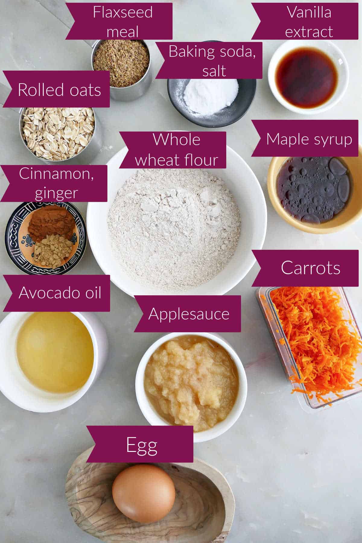 Oats, flaxseed, baking soda and salt, vanilla, spices, flour, syrup, oil, applesauce, carrots, and egg.