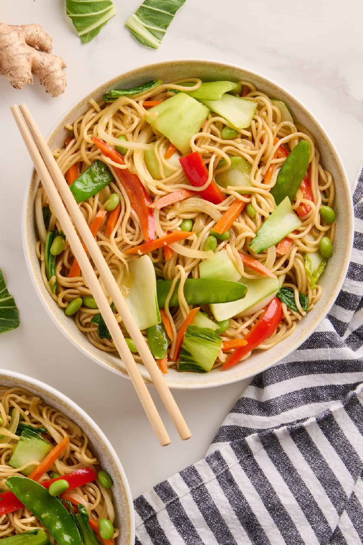Bok choy stir fry in a bowl with chopsticks on the side.