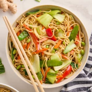 Bok choy stir fry in a bowl with chopsticks on the side.