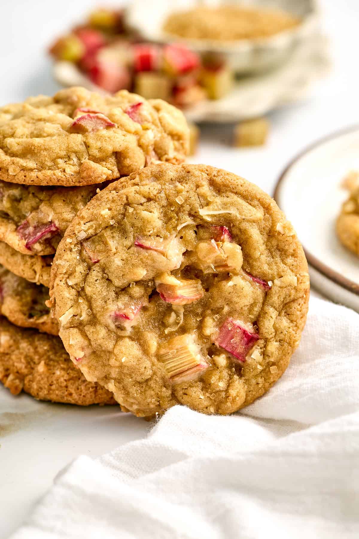 Stack of rhubarb cookies with one in the front on a counter.