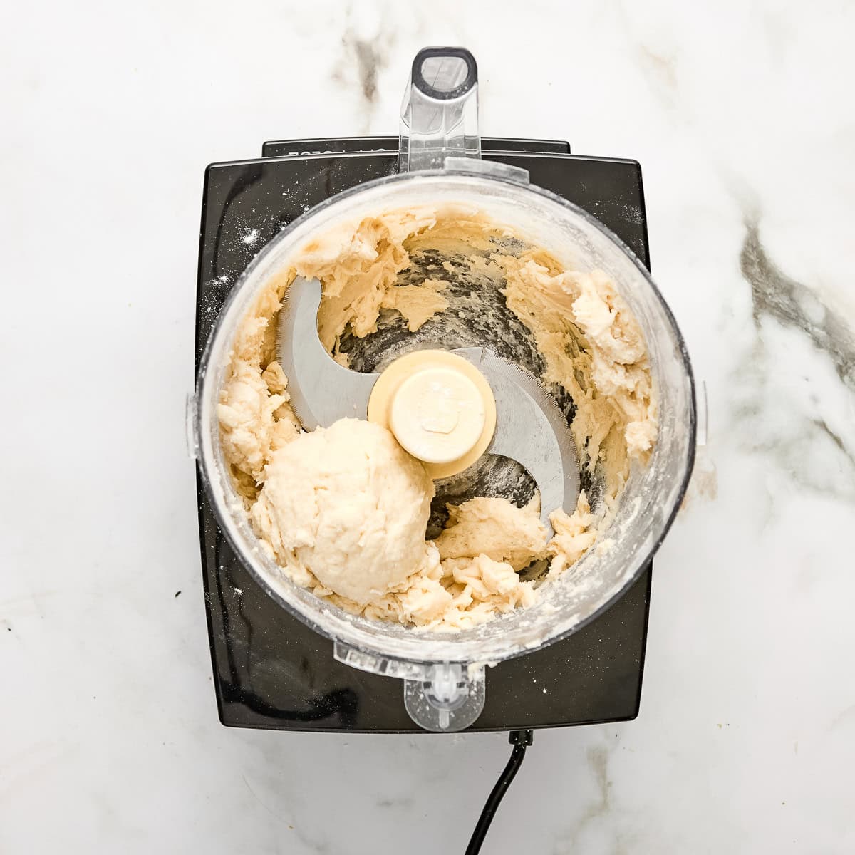 Galette dough after being mixed in a food processor.