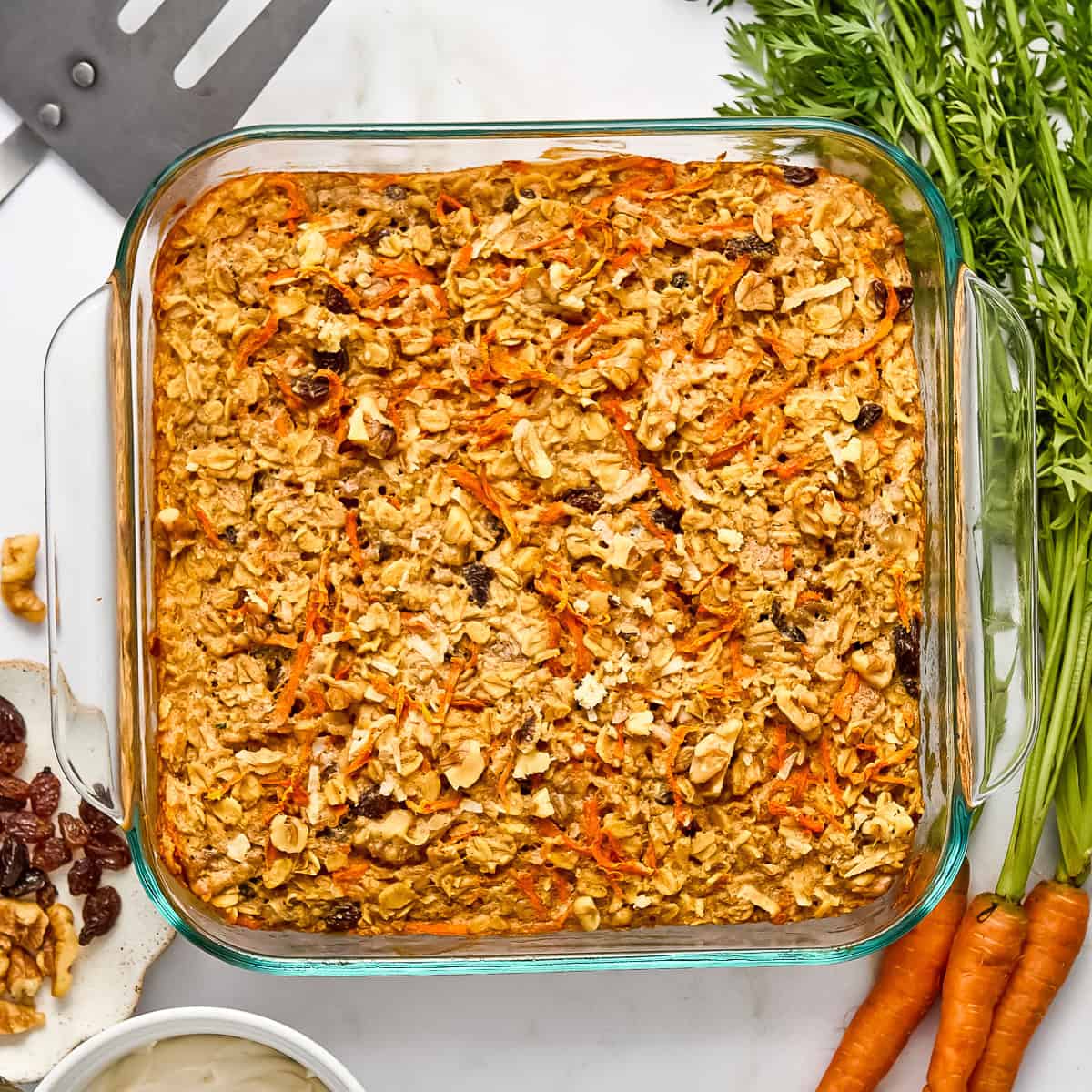 Carrot cake baked oats in a baking dish after coming out of the oven.