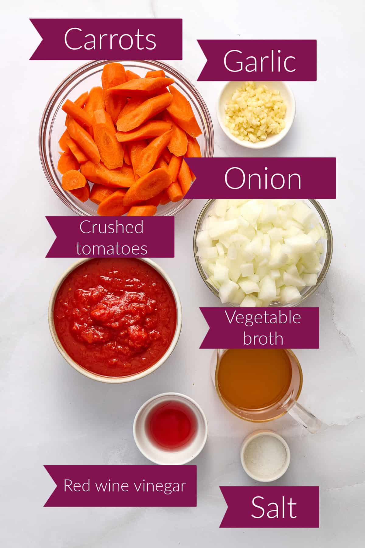 Carrots, garlic, onion, tomatoes, broth, red wine vinegar, and salt in bowls with labels.