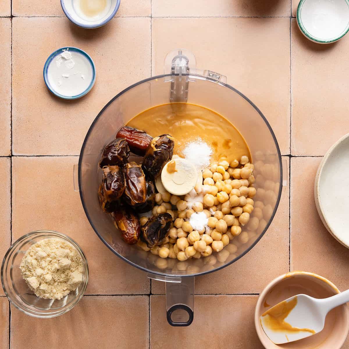 Soaked dates, chickpeas, peanut butter, baking powder, baking soda, and salt in a food processor.
