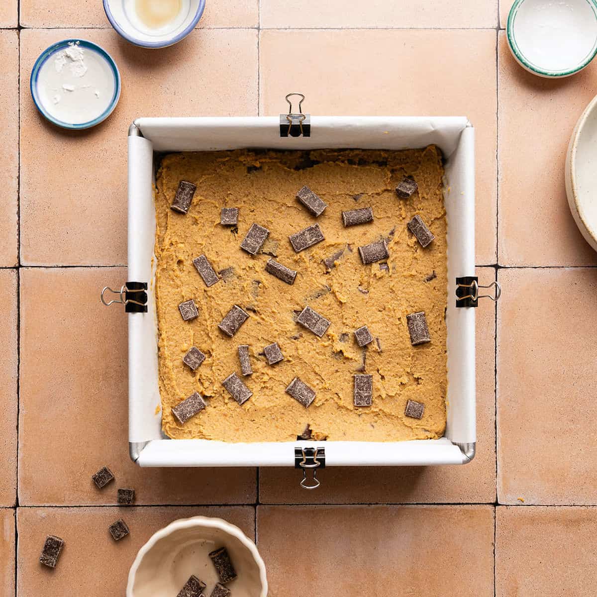 Chocolate chunks pressed into the top of chickpea blondie batter before going in the oven.