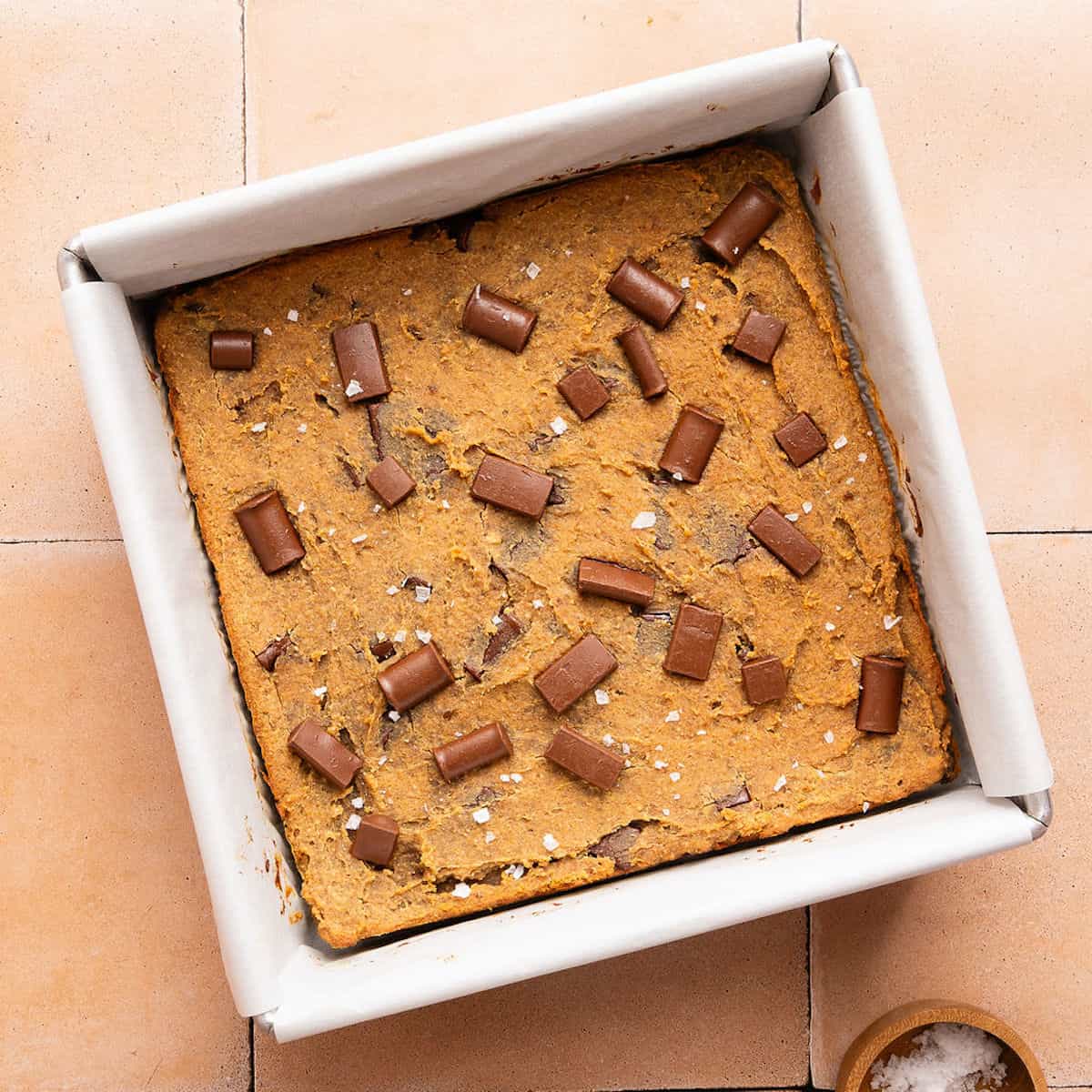 Chickpea blondies with chocolate chunks and flaky salt after coming out of the oven.