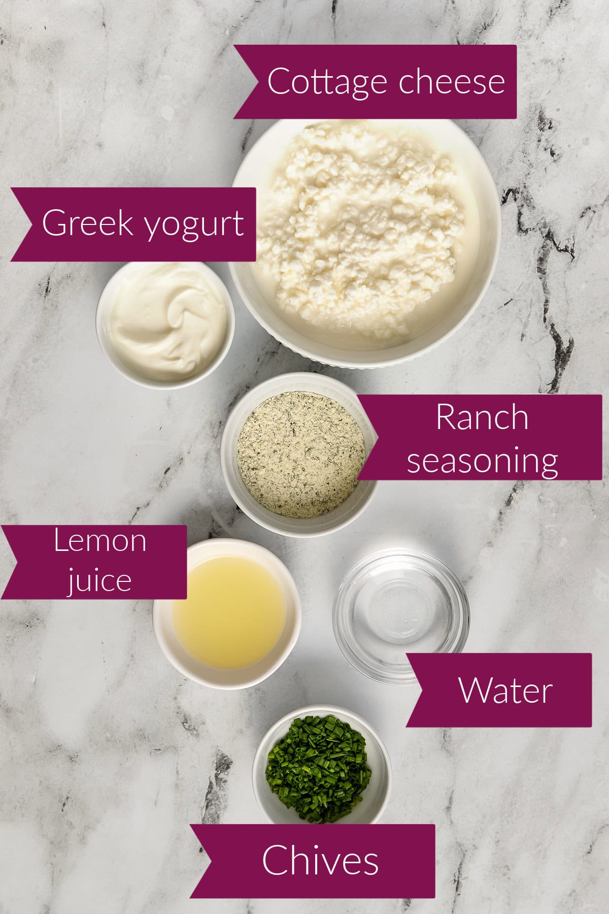 Cottage cheese, Greek yogurt, ranch seasonings, lemon juice, water, and chives on a counter with labels.