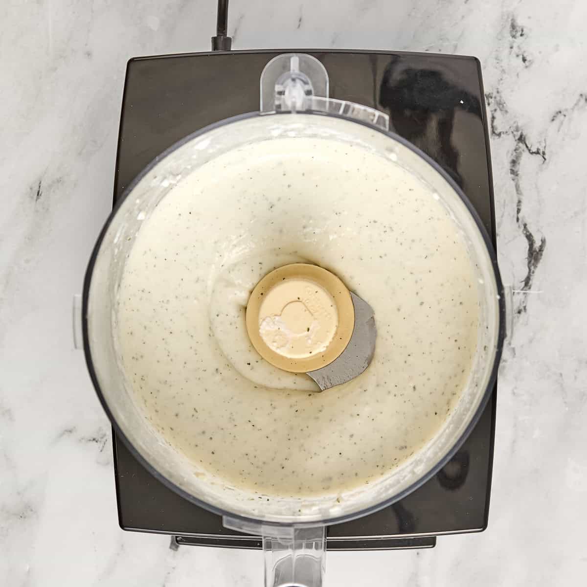 Creamy cottage cheese ranch dip in a food processor after being blended.