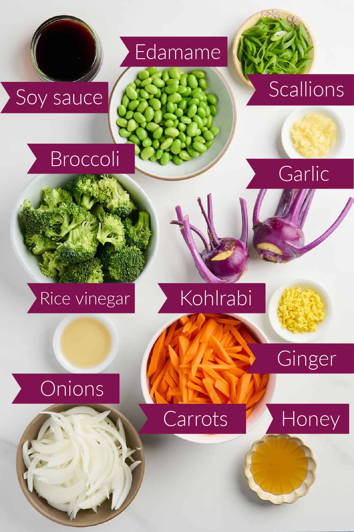 Soy sauce, edamame, scallions, garlic, broccoli, kohlrabi, ginger, vinegar, carrots, onion, and honey with labels.