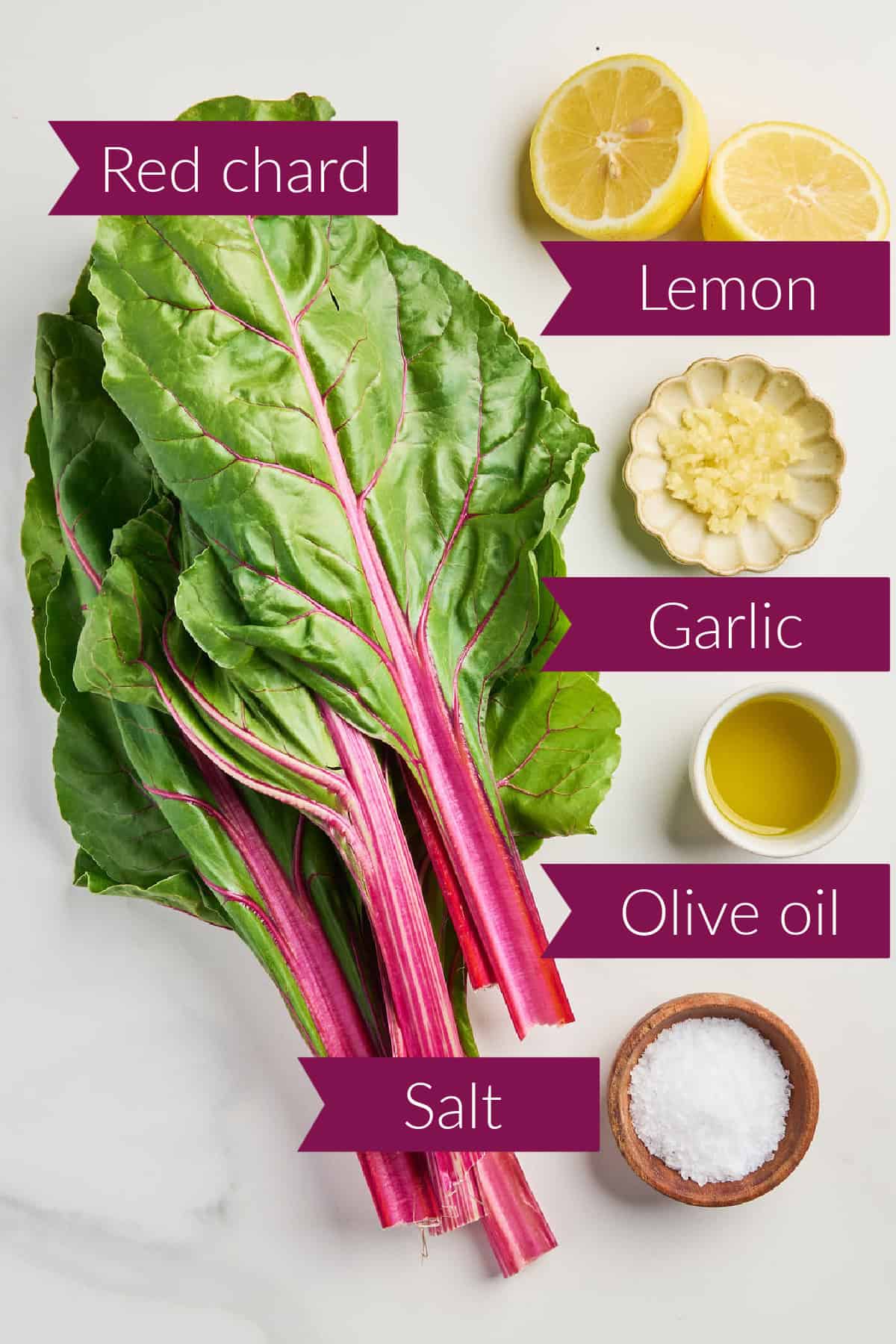 Red chard, lemon, garlic, olive oil, and salt on a counter with labels.