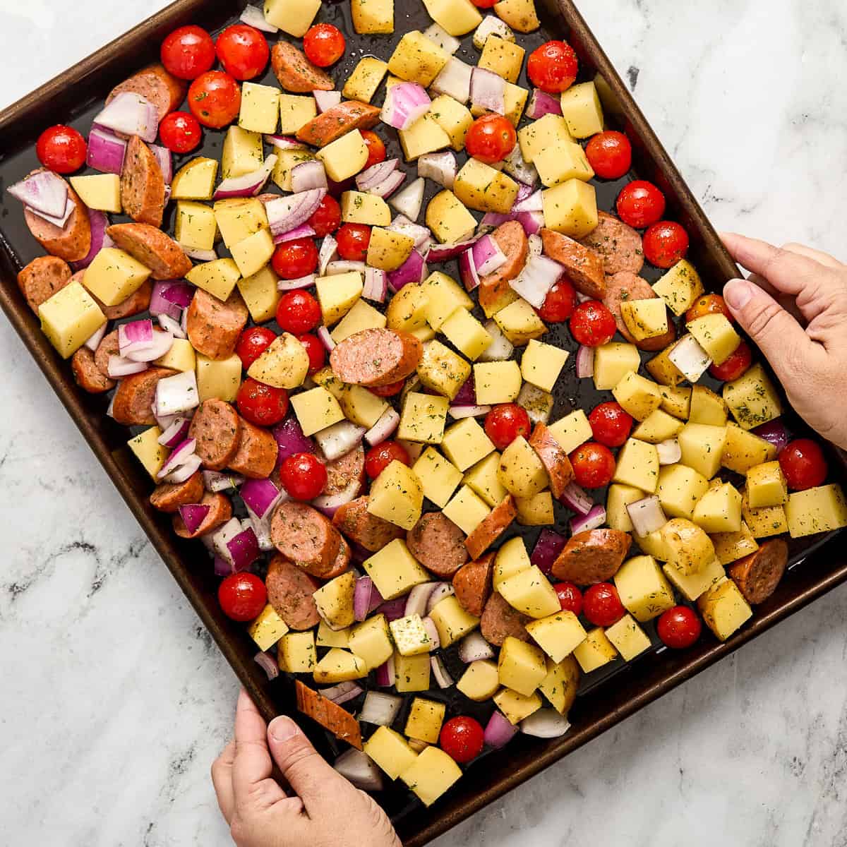 Chicken sausage sheet pan on a baking sheet before going into the oven.