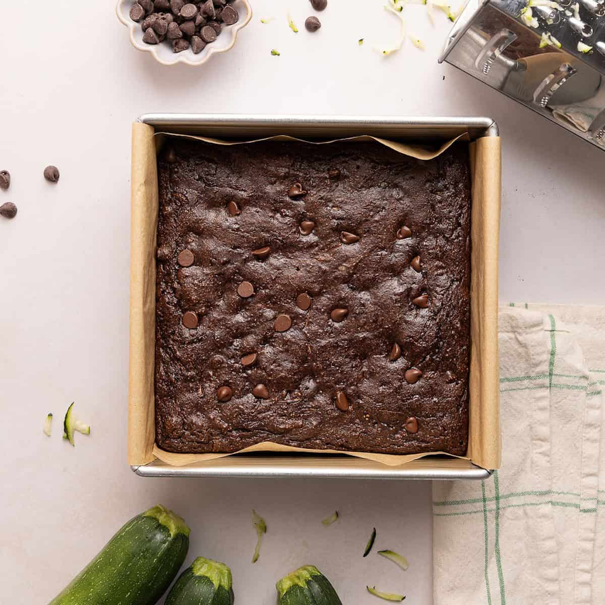 Chocolate brownies with zucchini in a baking pan after coming out of the oven.