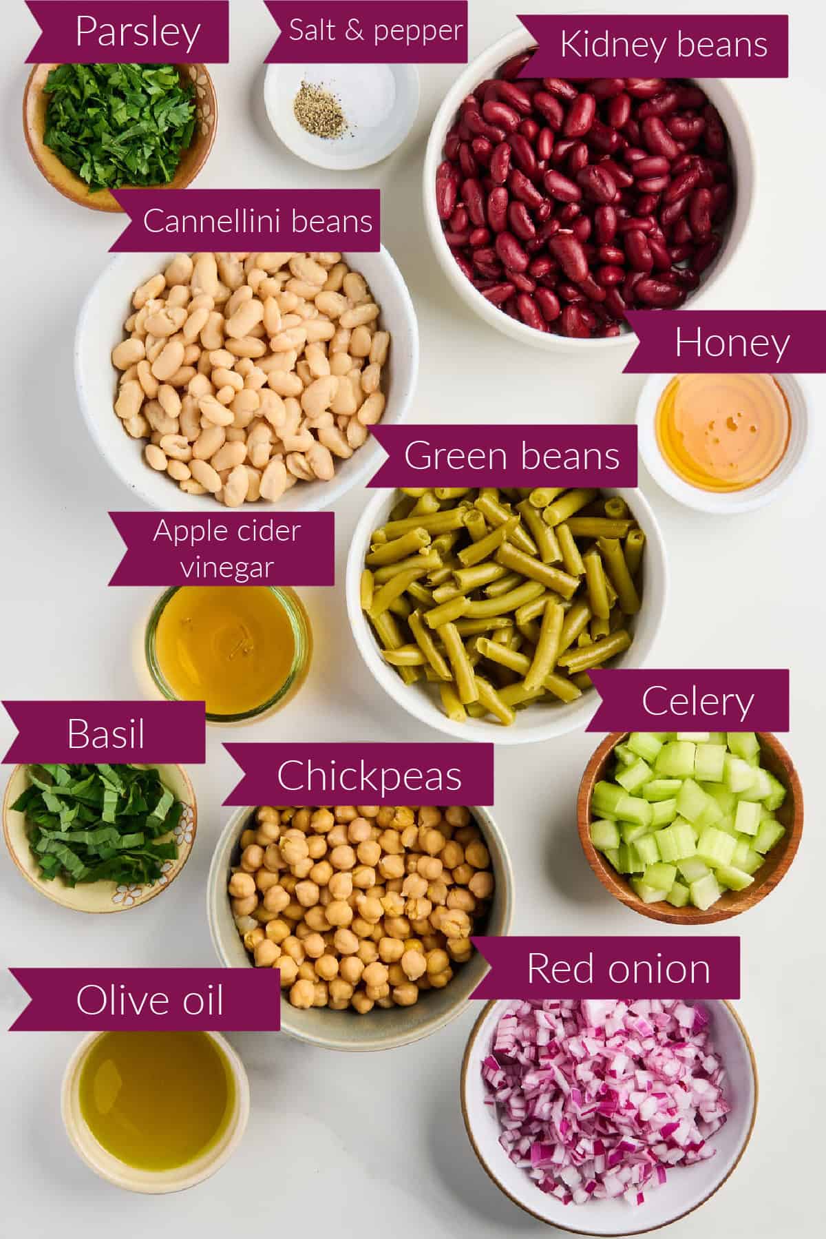 Parsley, salt, pepper, kidney beans, white beans, honey, vinegar, green beans, basil, chickpeas, celery, oil, and onion.