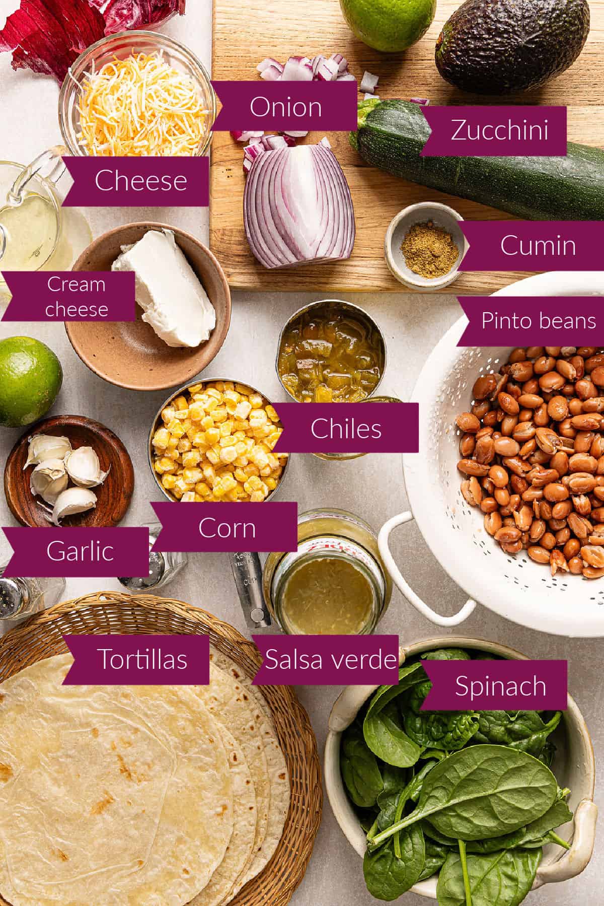 Cheese, cream cheese, onion, cumin, zucchini, garlic, corn, chiles, beans, tortillas, salsa, and spinach with labels.