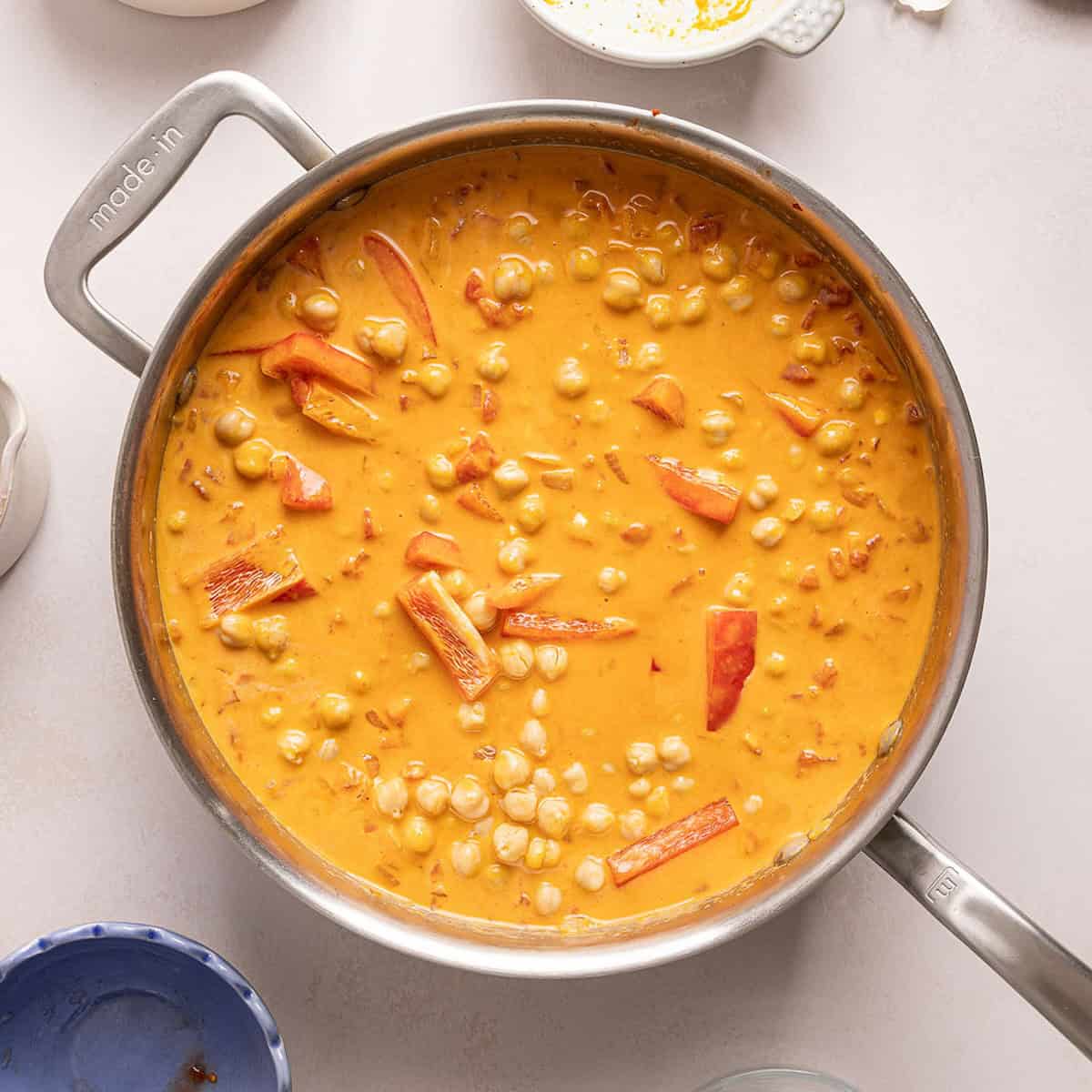 Pumpkin curry cooking until thickened in a large skillet.