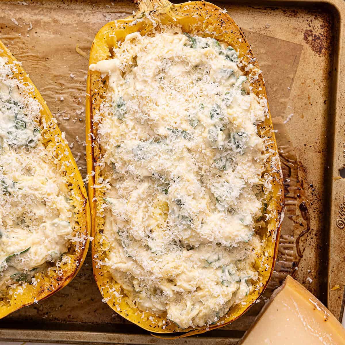 Spaghetti squash alfredo boat with parmesan cheese before going in the oven.