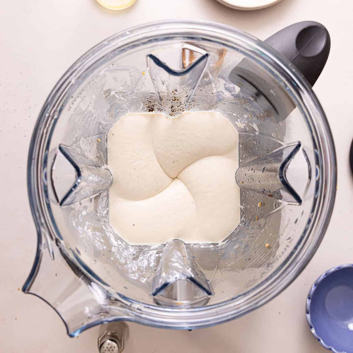 Healthy alfredo sauce in a blender after being blended.